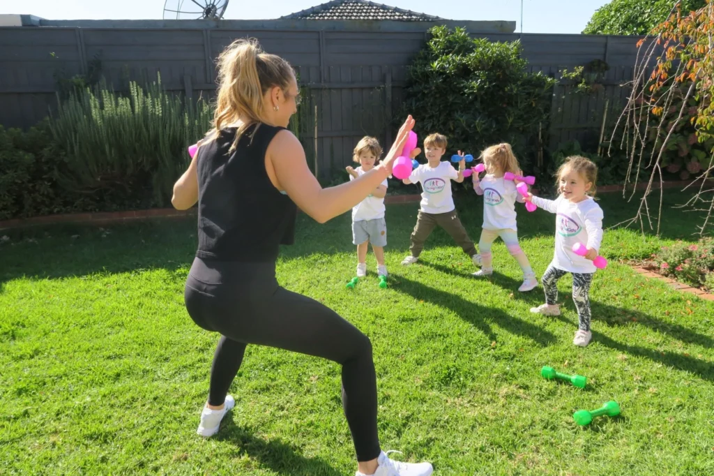 A mother is teaching squats morning exercise to her kids Squats morning exercise for kids